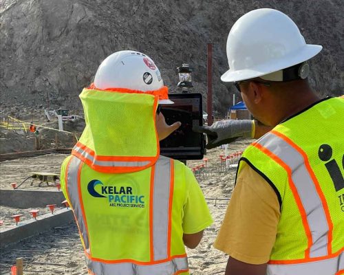 Kelar Pacific training subcontractor on robotic total station field layout - two people using the BIM data via IPAD and prism.